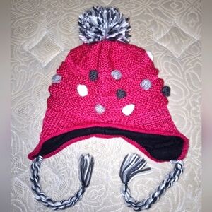 A pink Thinsulate pink toboggan with a pompom and knitted buttons all over.